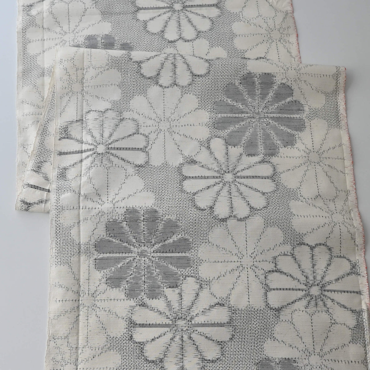 Vintage Japanese tsumugi silk kimono fabric with large round chrysanthemum pattern  in grey.