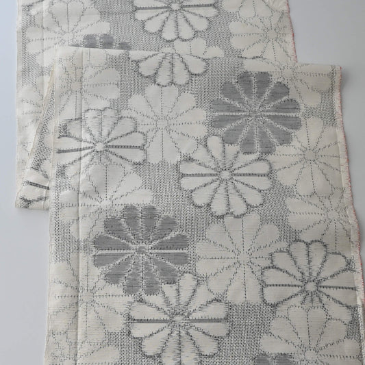 Vintage Japanese tsumugi silk kimono fabric with large round chrysanthemum pattern  in grey.