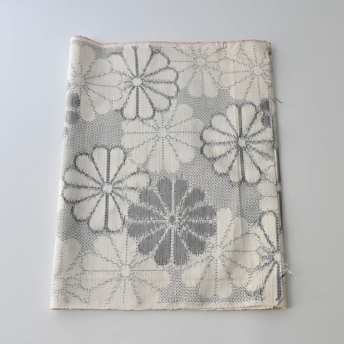 Vintage Japanese tsumugi silk kimono fabric with large round chrysanthemum pattern  in grey.
