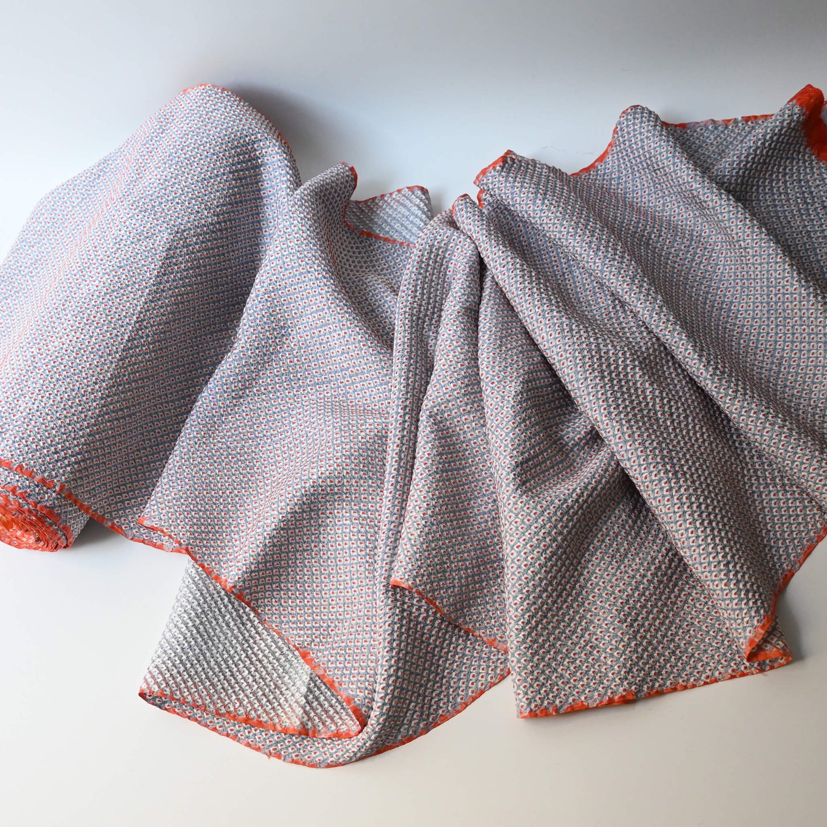 Full view of vintage silk shibori kimono fabric dyed with a misty blue-grey base and soft orange accents.