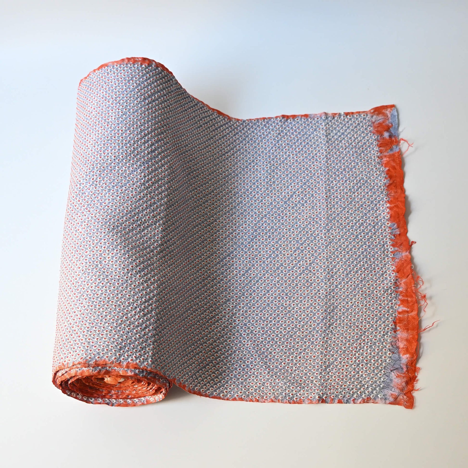 Vintage silk shibori kimono fabric dyed with a misty blue-grey base and soft orange accents.