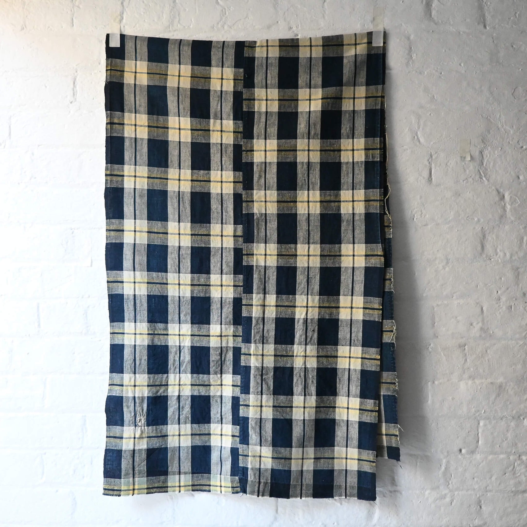 Full view of vintage Japanese two-panel indigo check cotton futon cover with a little patch.