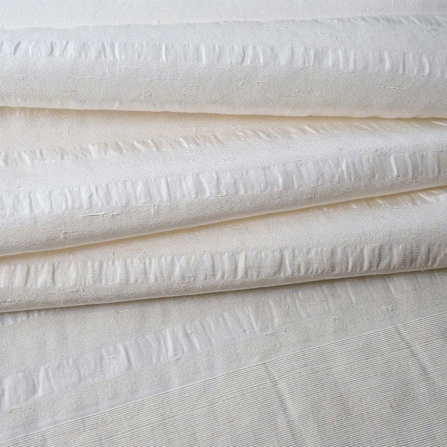 Close-up view of vintage undyed textured stripe silk kimono fabric sold by the metre.