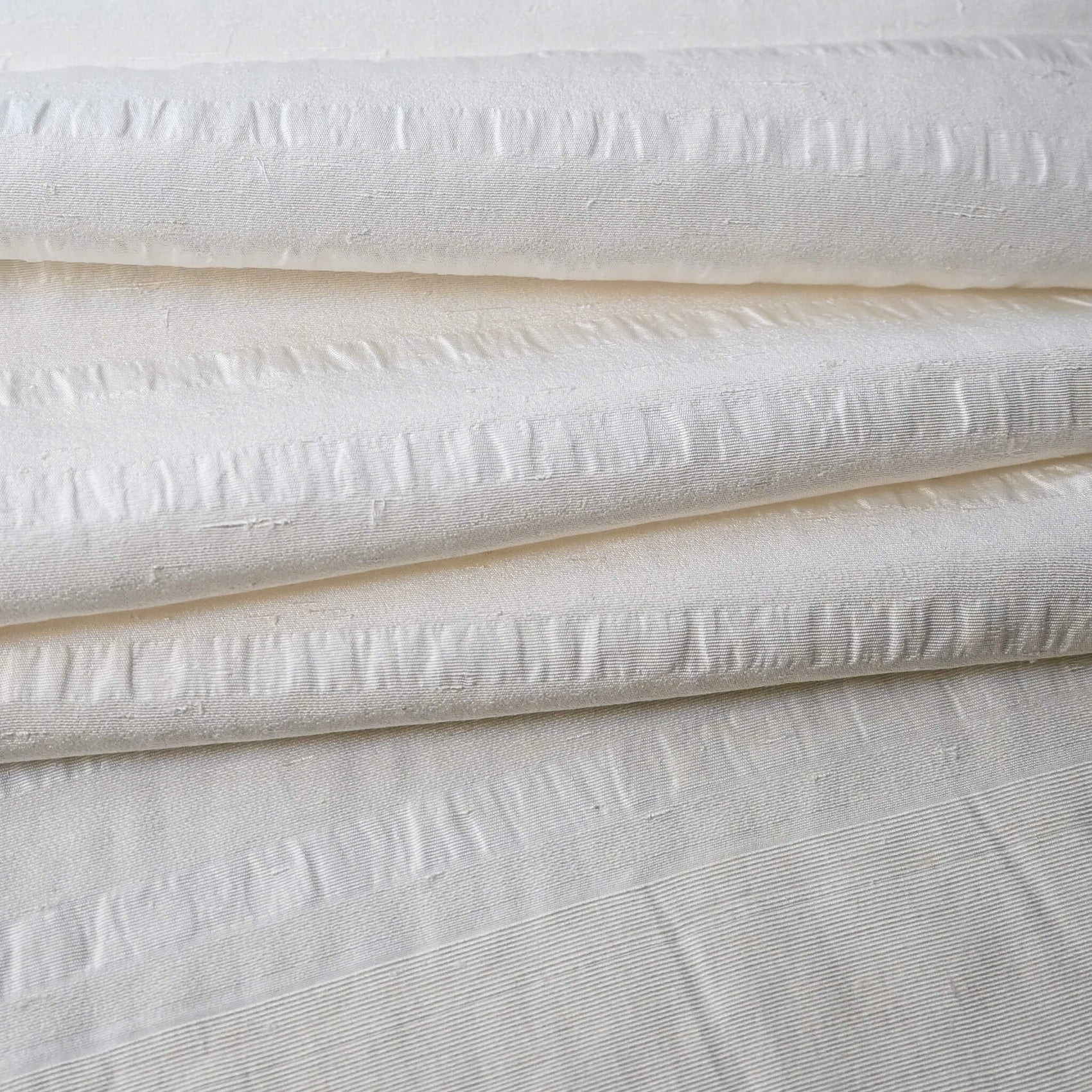 Close-up view of vintage undyed textured stripe silk kimono fabric sold by the metre.