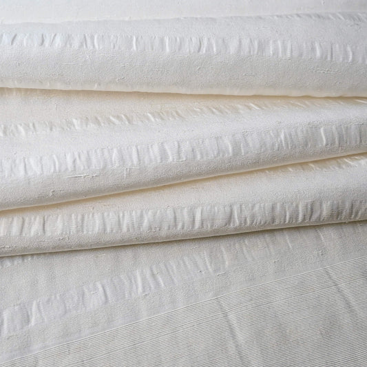 Close-up view of vintage undyed textured stripe silk kimono fabric sold by the metre.