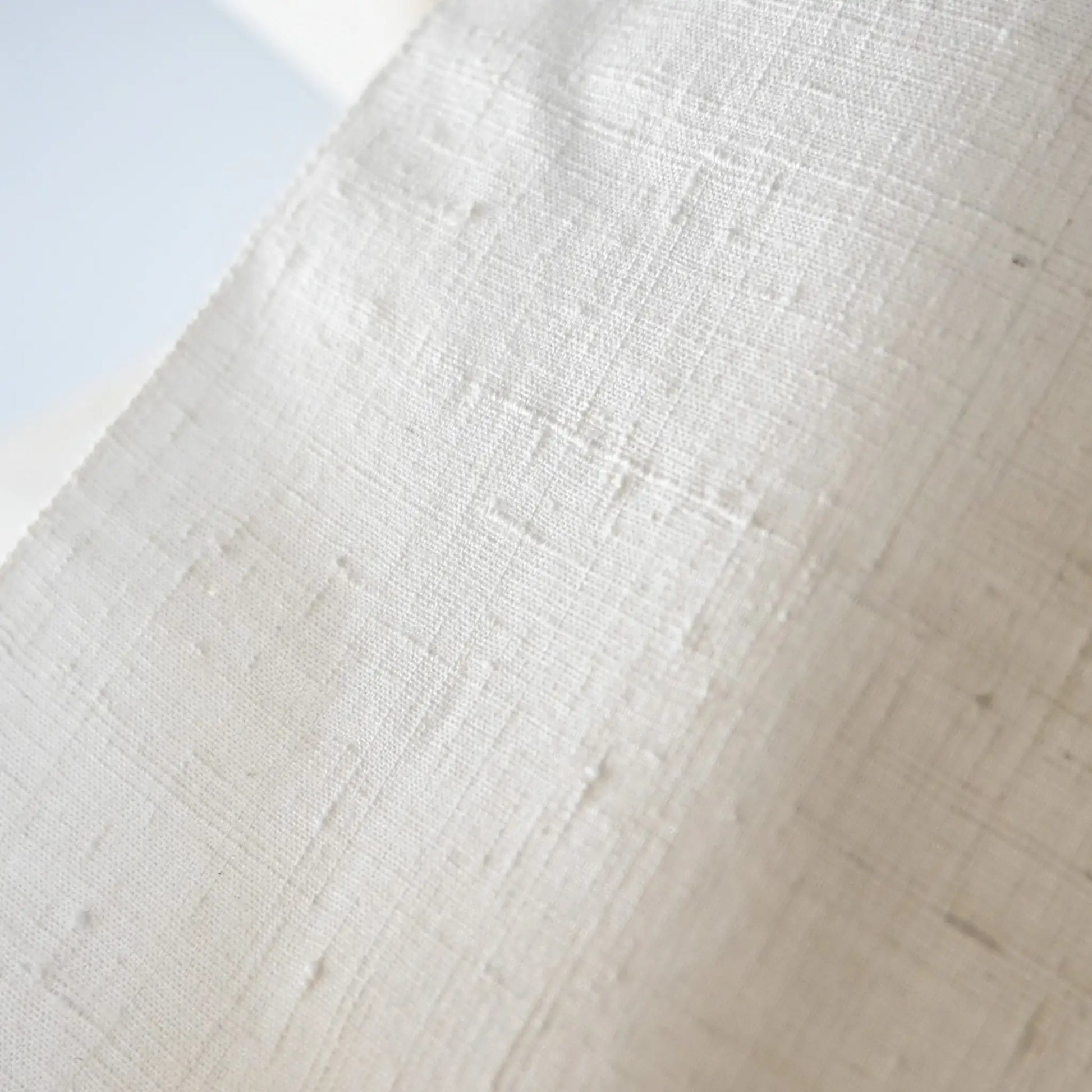 Close-up view of vintage undyed yuki-tsumugi silk with textured slobs, crisp hand, ideal for dyeing projects.