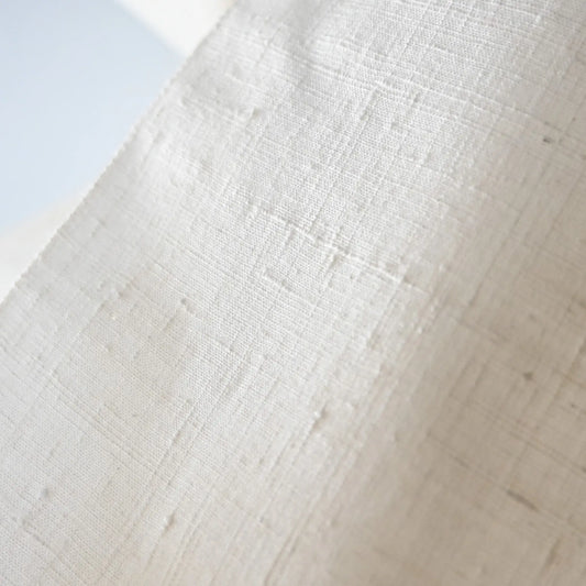 Close-up view of vintage undyed yuki-tsumugi silk with textured slobs, crisp hand, ideal for dyeing projects.