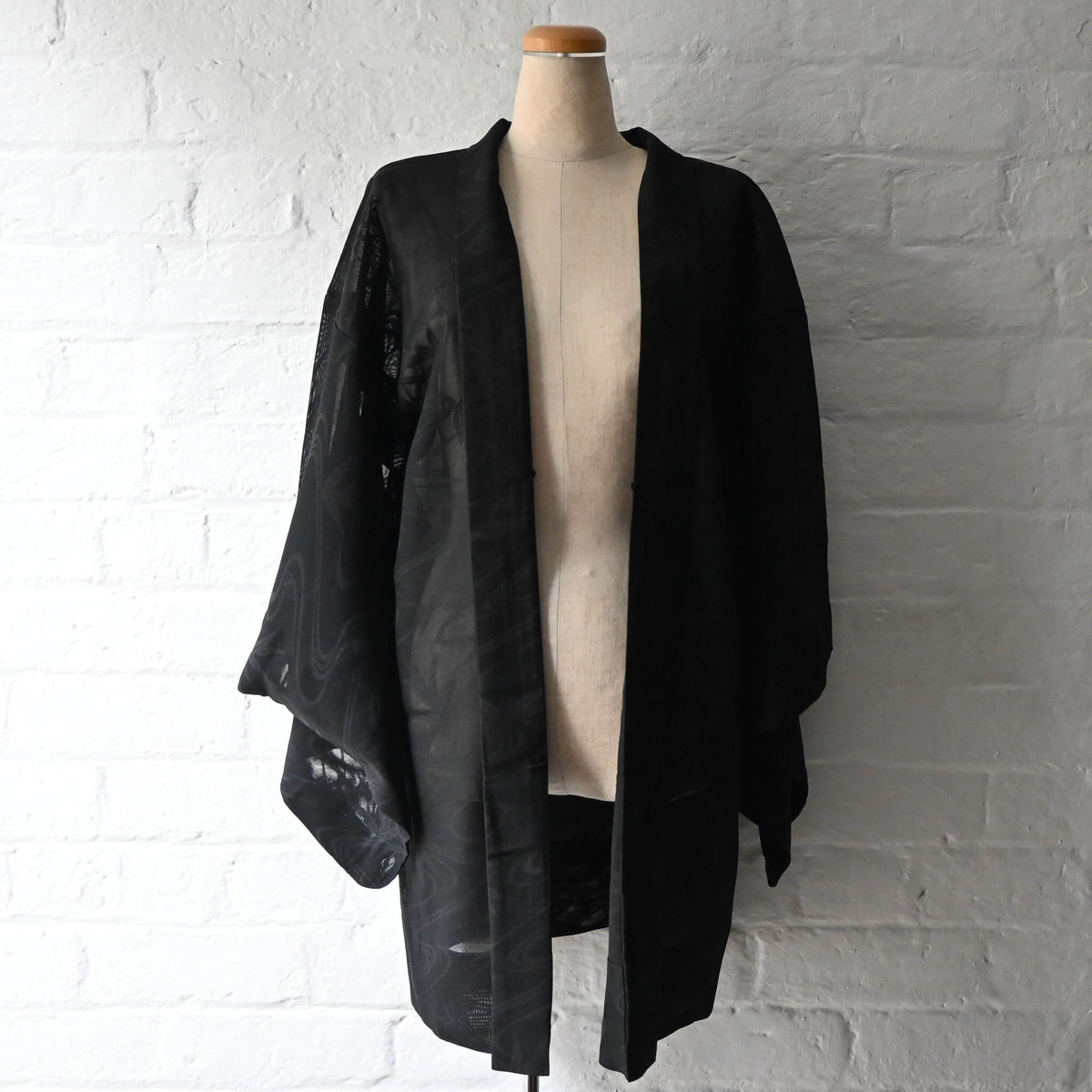 Vintage women's unlined black sheer silk haori for summer, with woven running water and bamboo motifs.