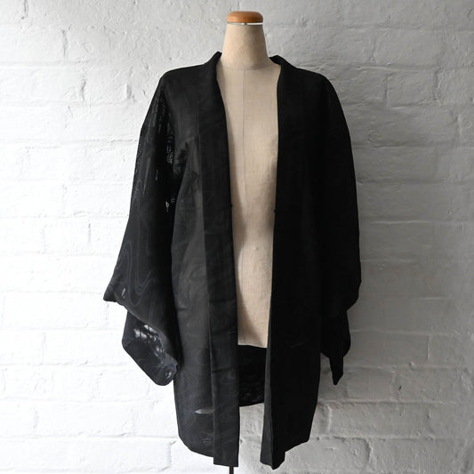 Vintage women's unlined black sheer silk haori for summer, with woven running water and bamboo motifs.