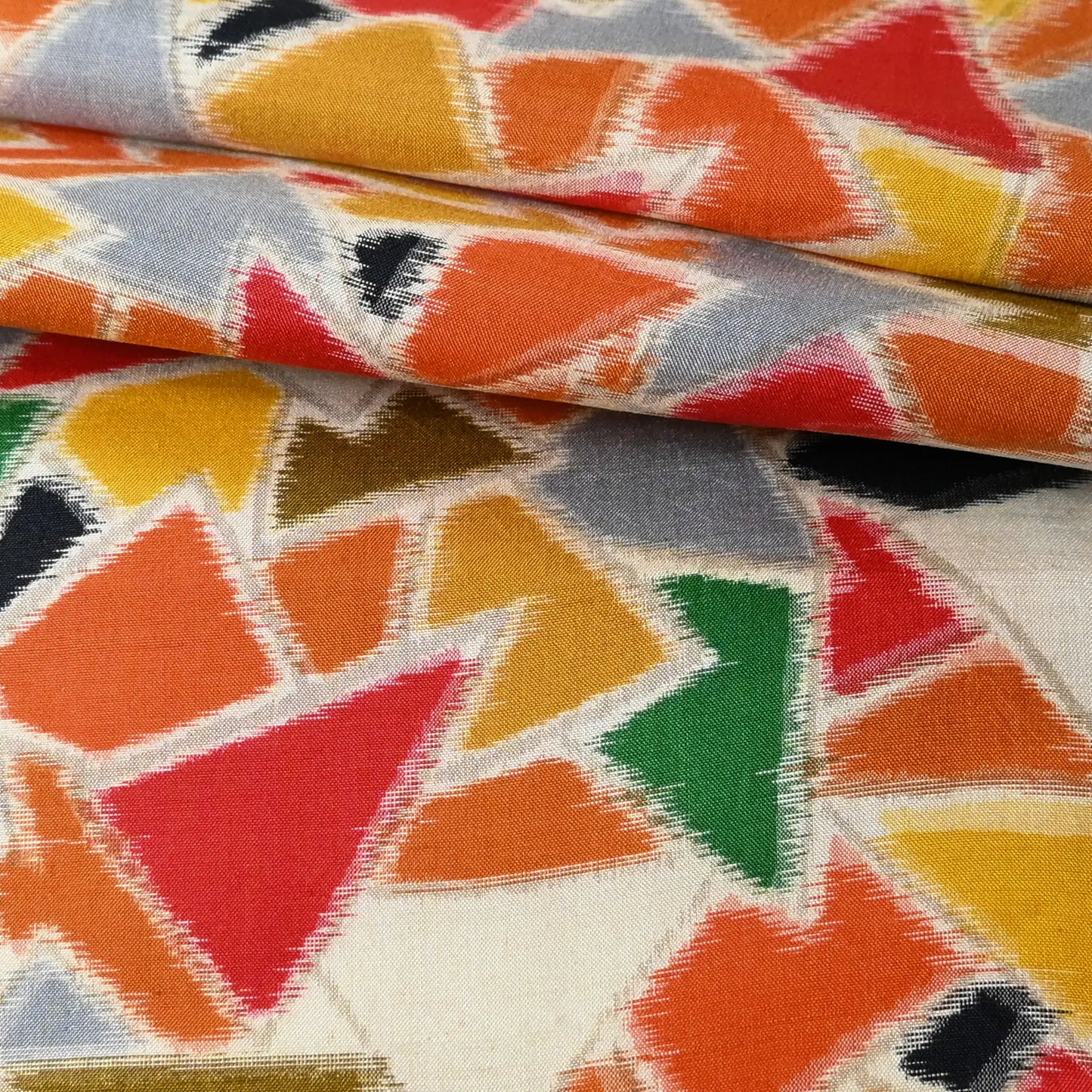 Detailed view of vintage vibrant geometric Meisen silk kimono fabric piece from mid-20th century.