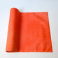 Vintage tsumugi silk kimono fabric in vibrant vermillion orange sold by the metre.