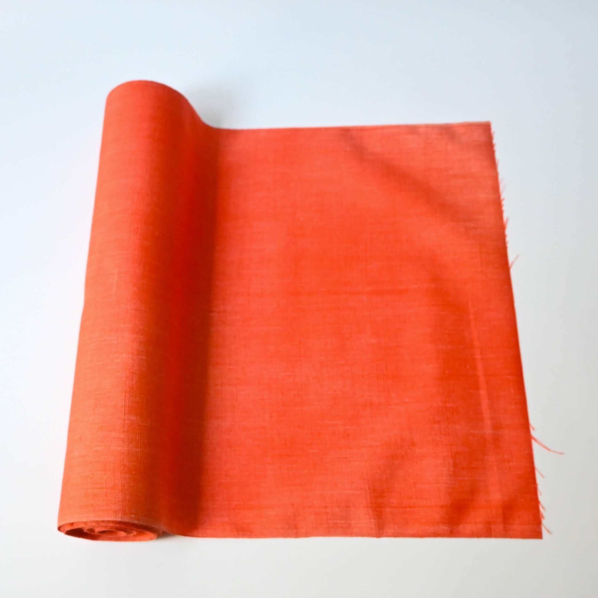 Vintage tsumugi silk kimono fabric in vibrant vermillion orange sold by the metre.
