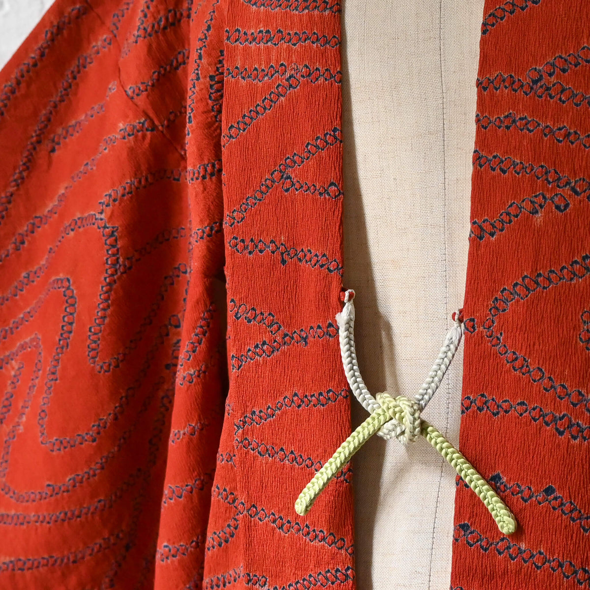 Vintage women’s burnt orange silk shibori haori with organic line motifs in deep blue.