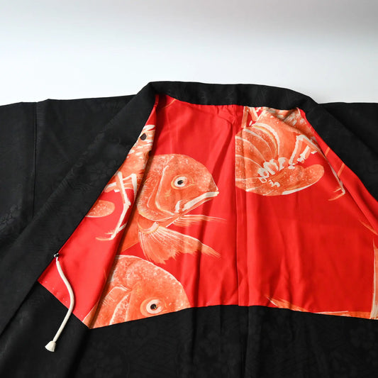 Vintage women's black silk haori with red silk lining decorated with auspicious motifs of snapper and lobster.
