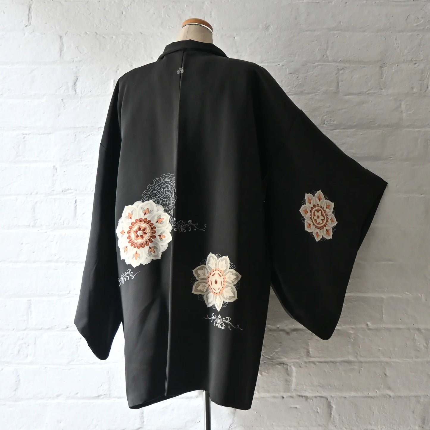 Vintage Japanese women's black silk haori with stylised floral motif.