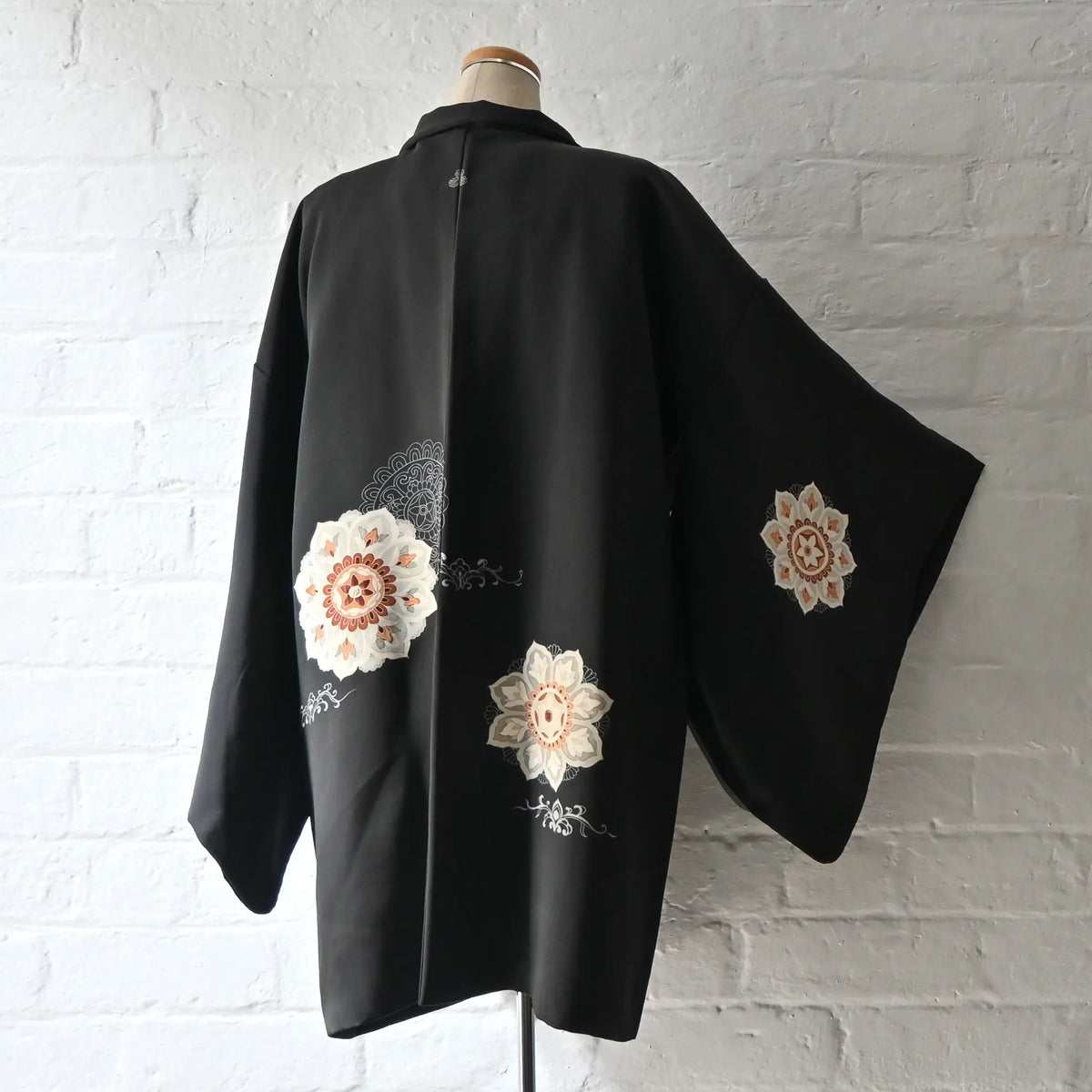 Vintage Japanese women's black silk haori with stylised floral motif.