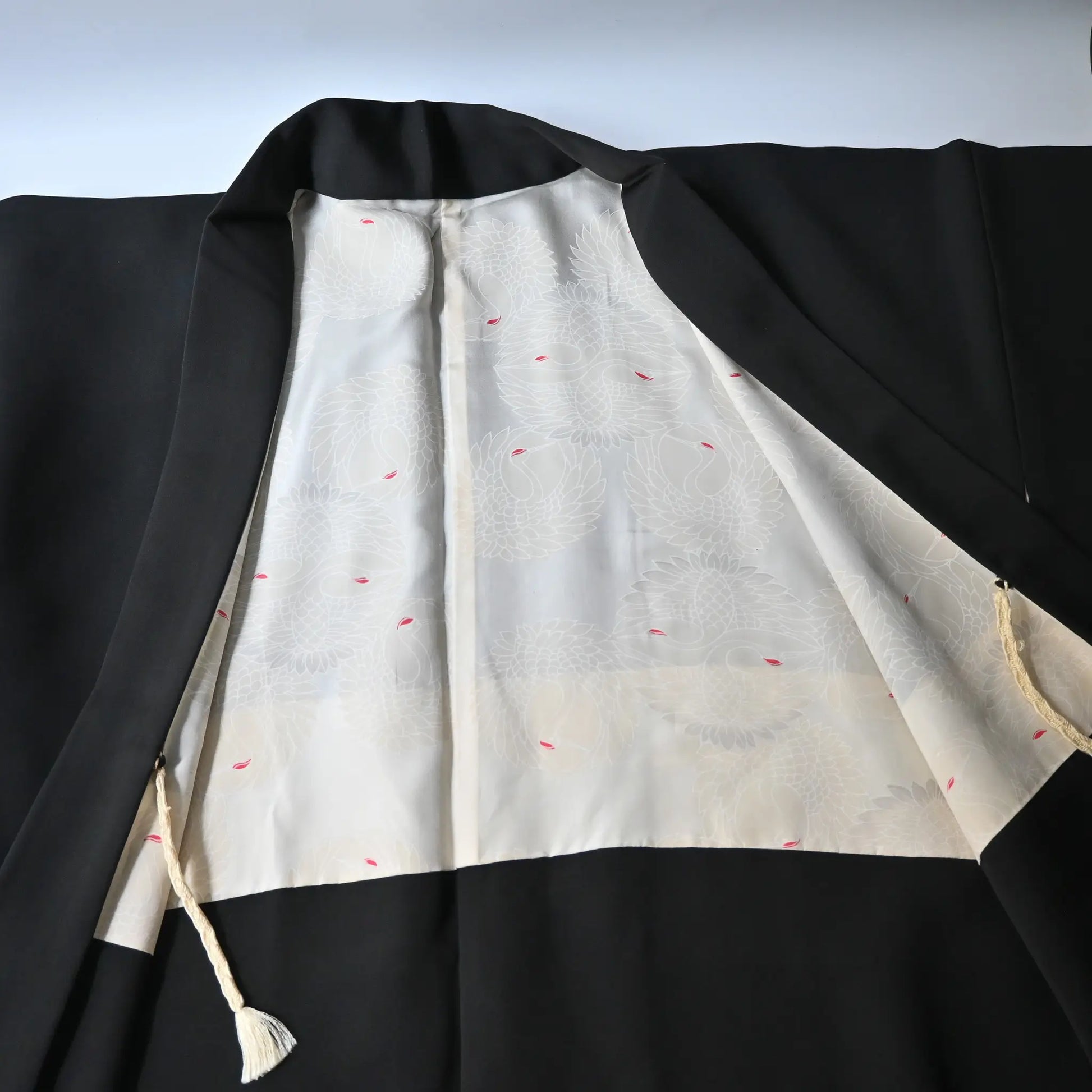 Vintage Japanese women's black silk haori with stylised floral motif.