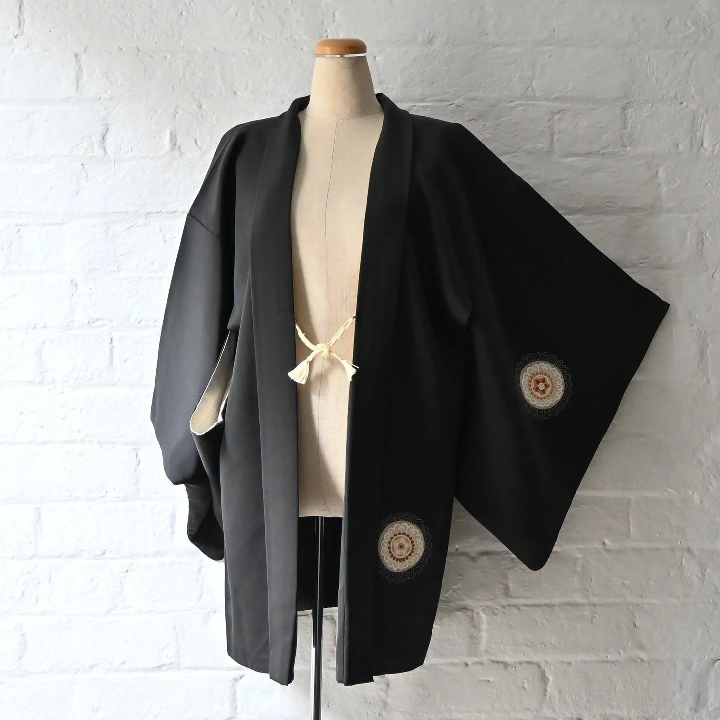 Vintage Japanese women's black silk haori with stylised floral motif.