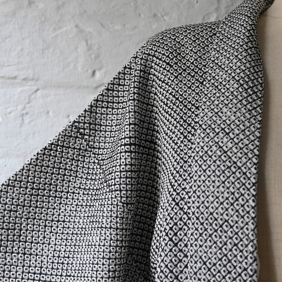 Close-up view of vintage women's black and white silk haori with all-over kanoko shibori pattern.