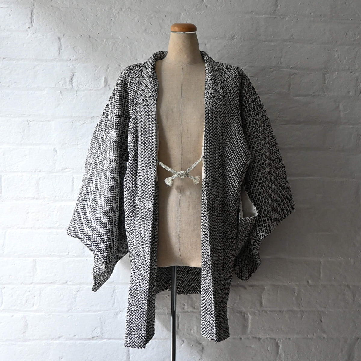 Vintage women's black and white silk haori with all-over kanoko shibori pattern.