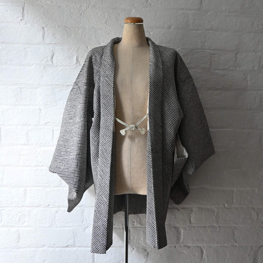 Vintage women's black and white silk haori with all-over kanoko shibori pattern.