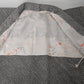 The lining of vintage women's black and white silk haori with all-over kanoko shibori pattern.