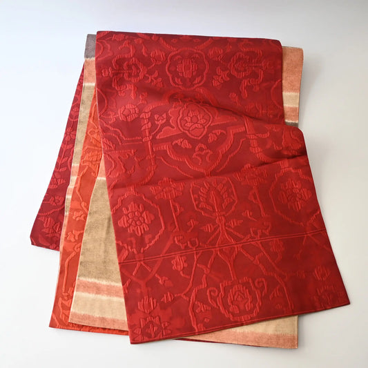 Full view of vintage women's silk Fukure-ori obi with oriental motif in burgundy red and orange.