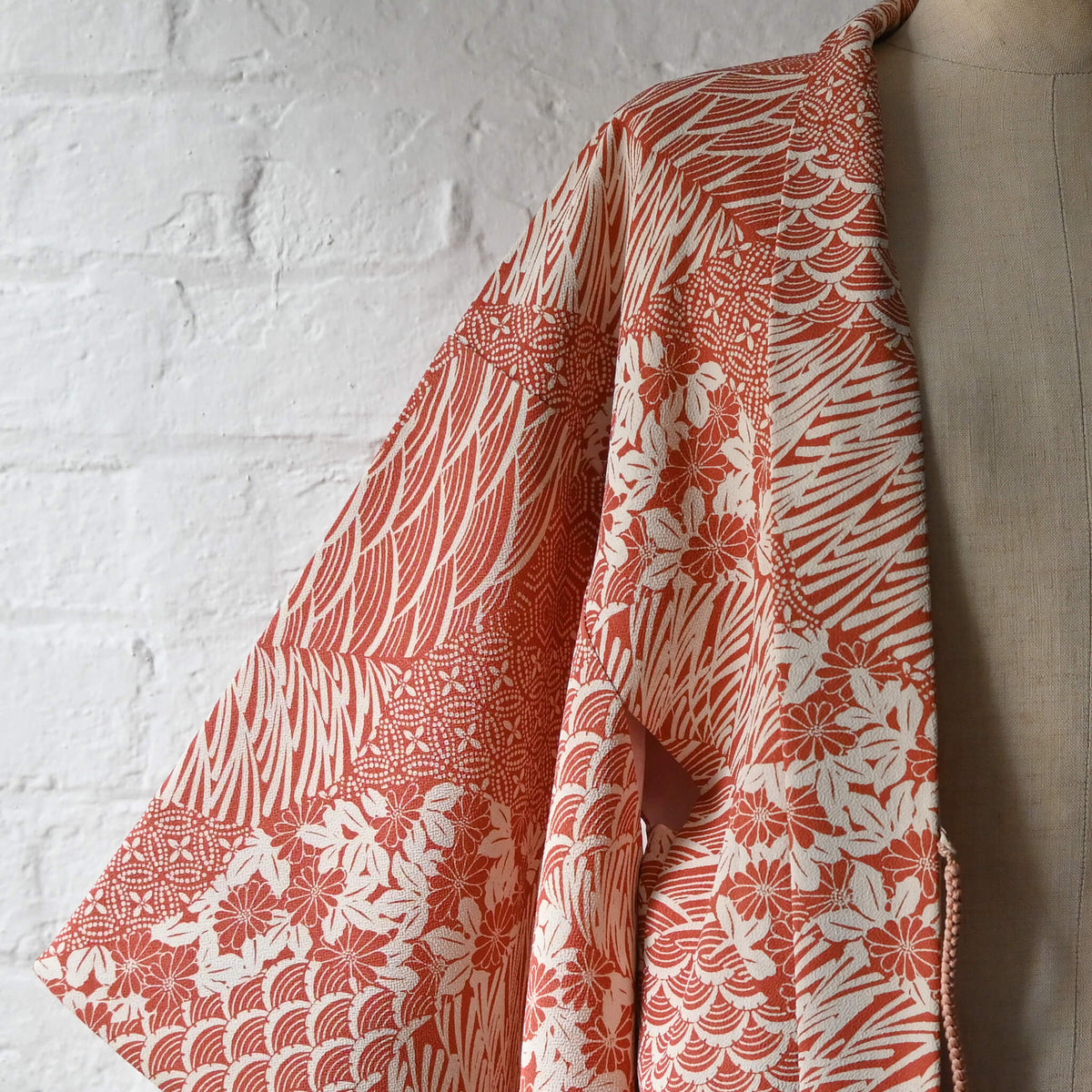 Vintage women's synthetic crepe haori in terracotta and ivory with floral and geometric patterns.