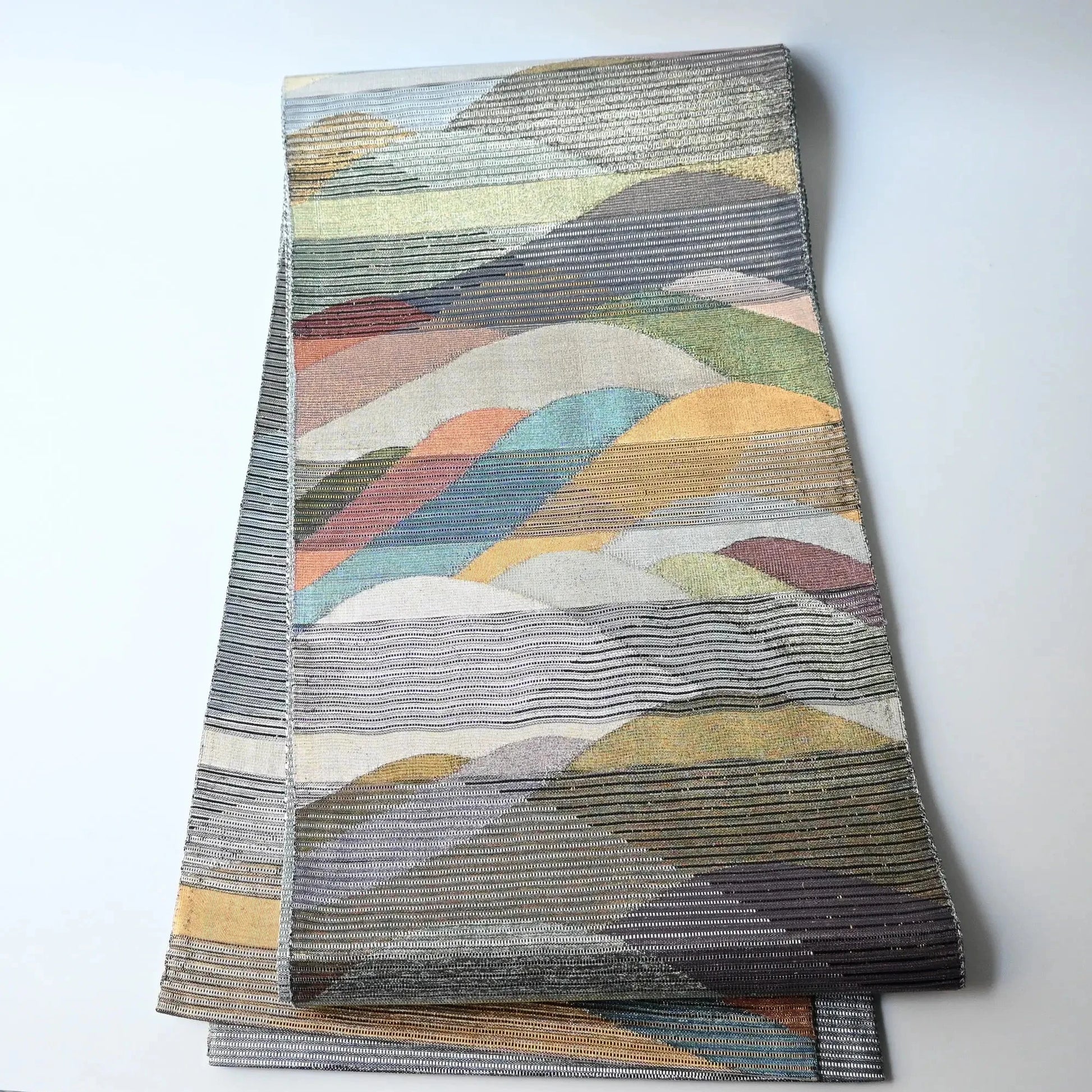 Full view of vintage Japanese women's silk metallic Bukuro obi with mountain design.