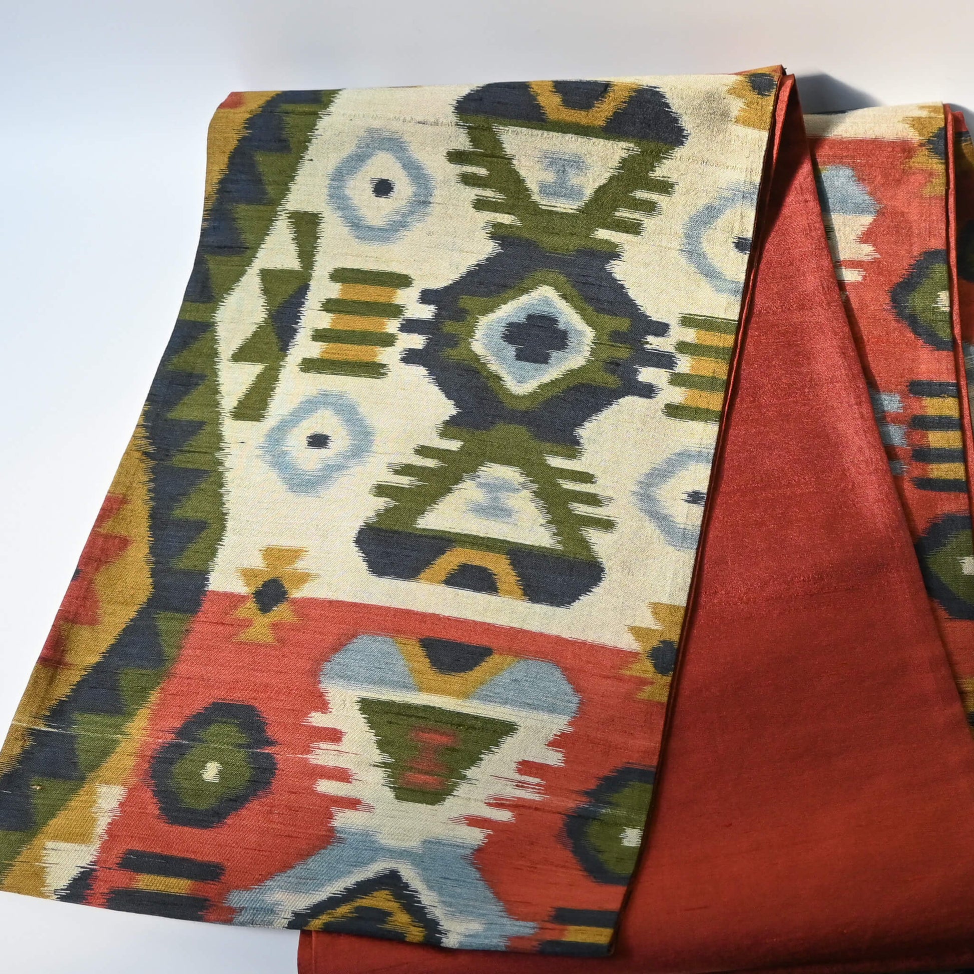 Vintage Japanese women's tsumugi silk Fukuro obi with abstract geometric design in rustic orange and green tone.