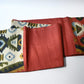 Detailed view of vintage Japanese women's tsumugi silk Fukuro obi with abstract geometric design in rustic orange and green tone.