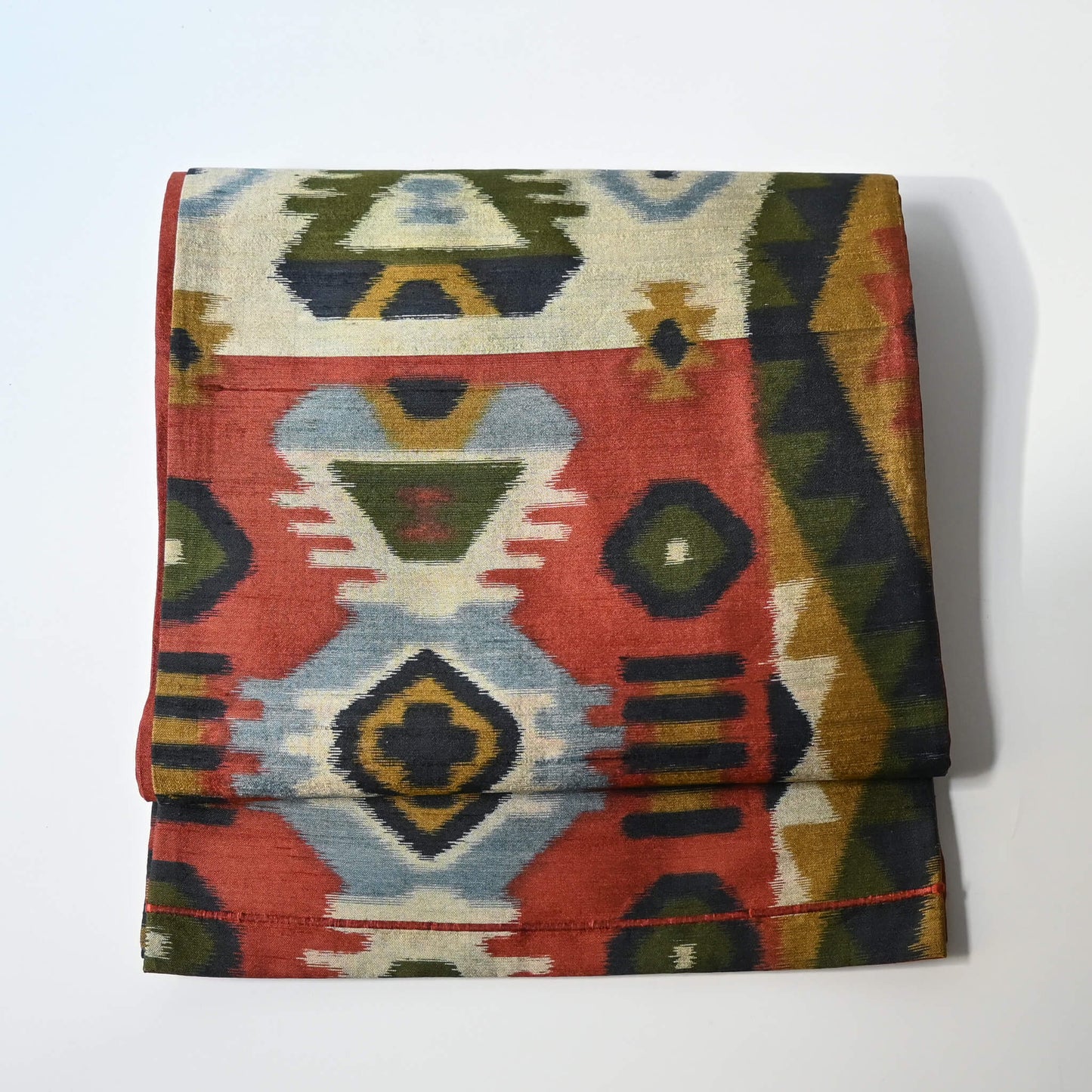 Vintage Japanese women's tsumugi silk Fukuro obi with abstract geometric design in rustic orange and green tone.