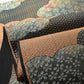 Detailed view of vintage Japanese women's silk fukuro obi in black and silver with cloud motif.