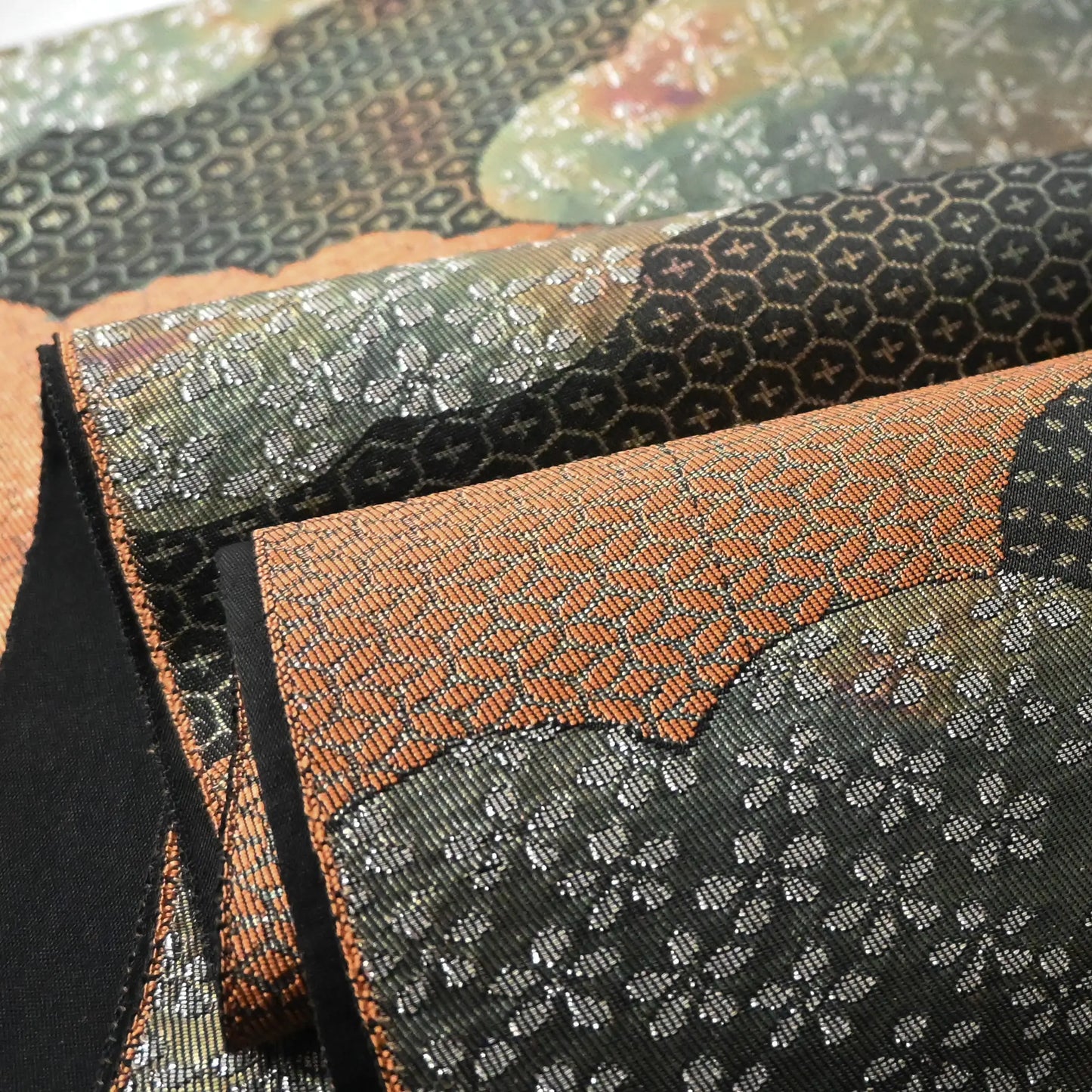 Detailed view of vintage Japanese women's silk fukuro obi in black and silver with cloud motif.