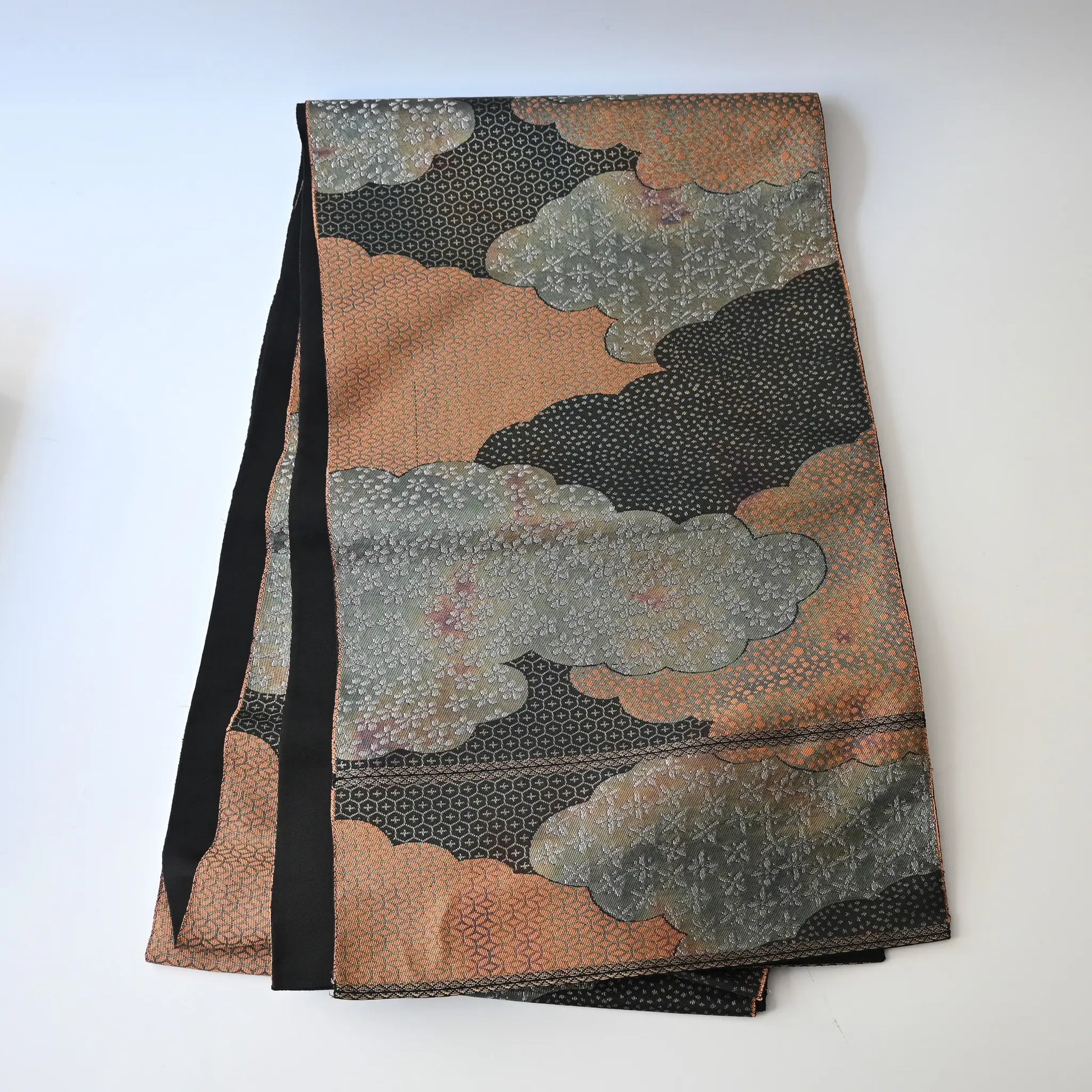 Full view of vintage Japanese women's silk fukuro obi in black and silver with cloud motif.