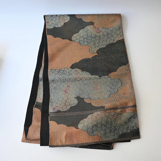 Full view of vintage Japanese women's silk fukuro obi in black and silver with cloud motif.
