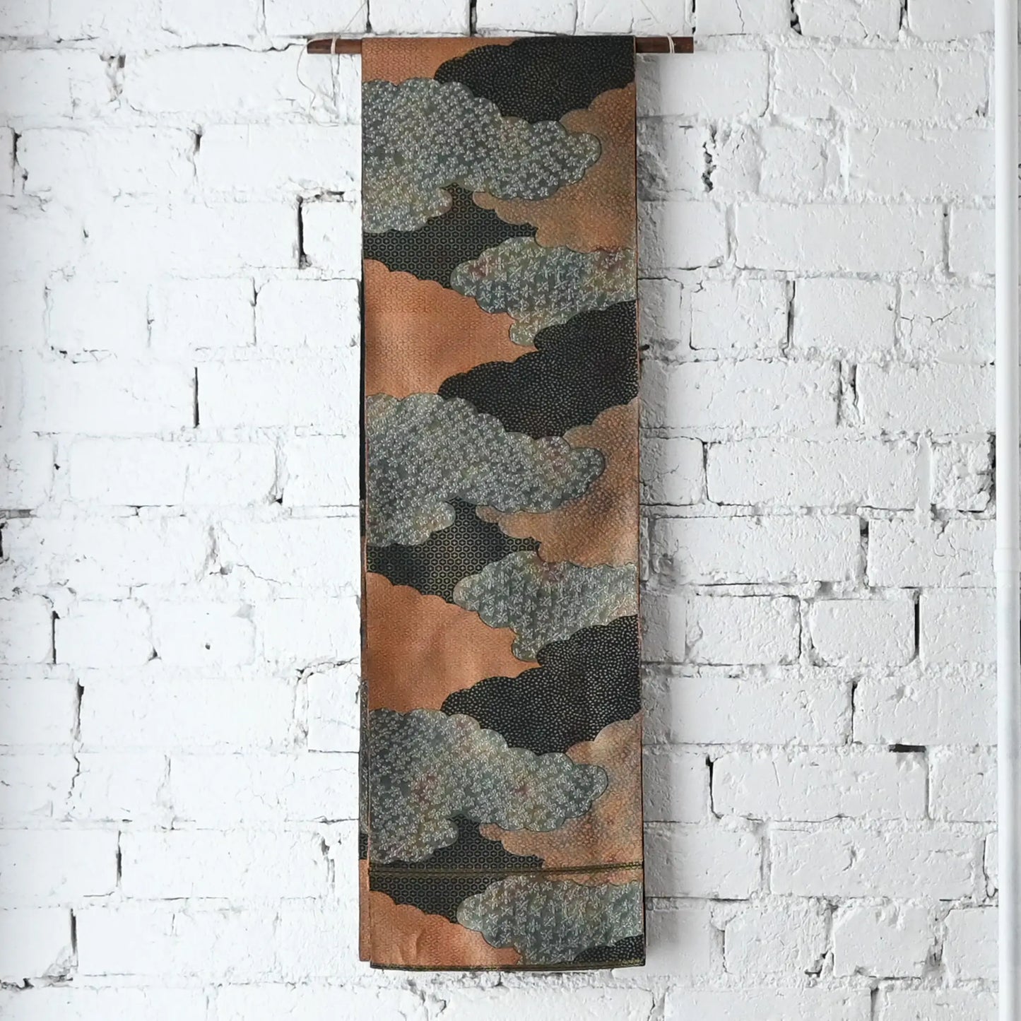 Hanging view of vintage Japanese women's silk fukuro obi in black and silver with cloud motif.