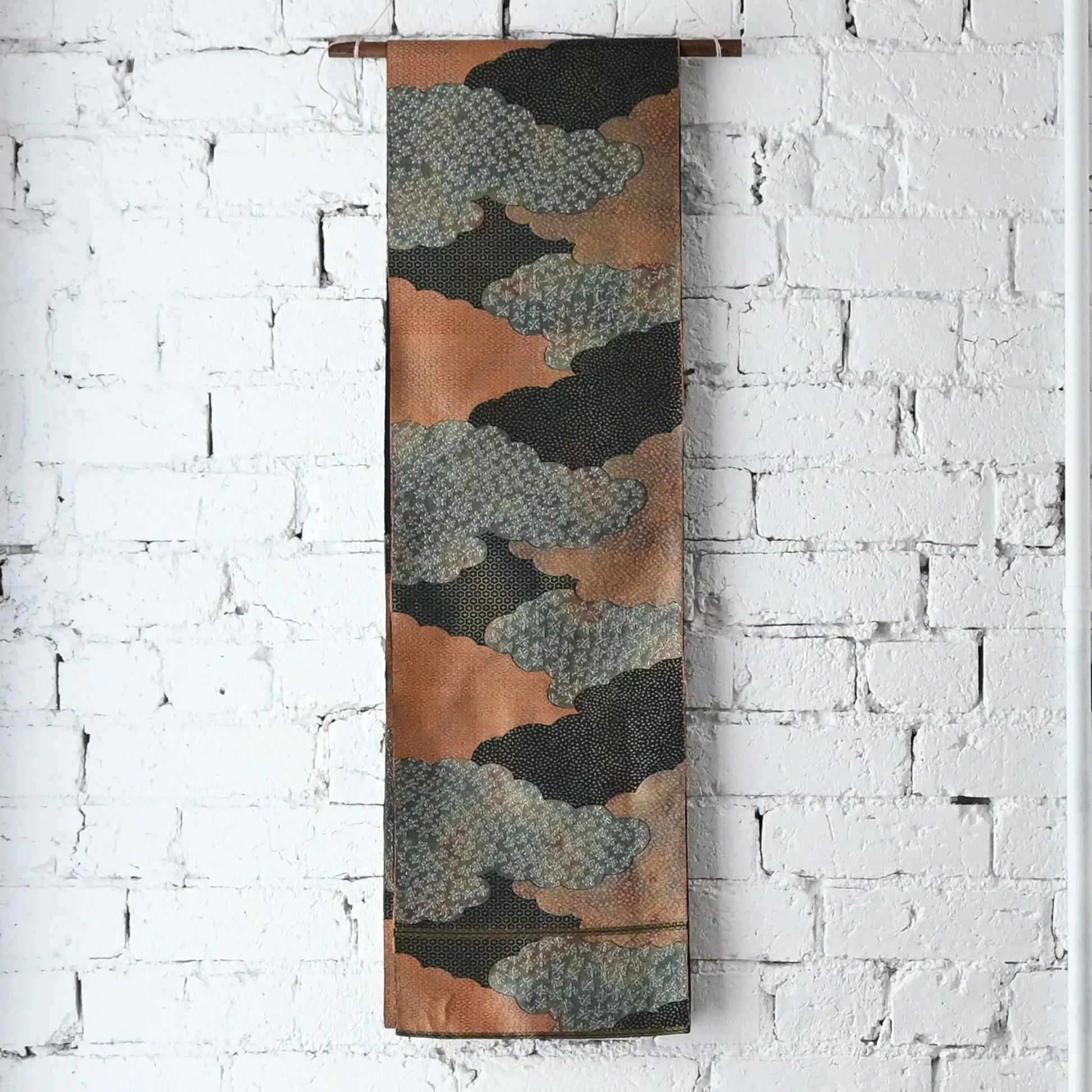Hanging view of vintage Japanese women's silk fukuro obi in black and silver with cloud motif.