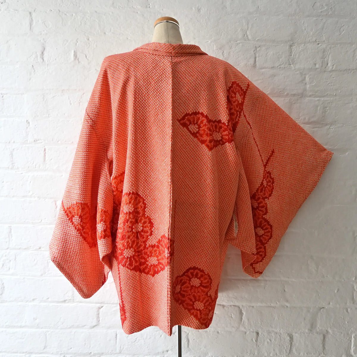 Vintage Japanese women's orange silk shibori haori with chrysanthemum motif.