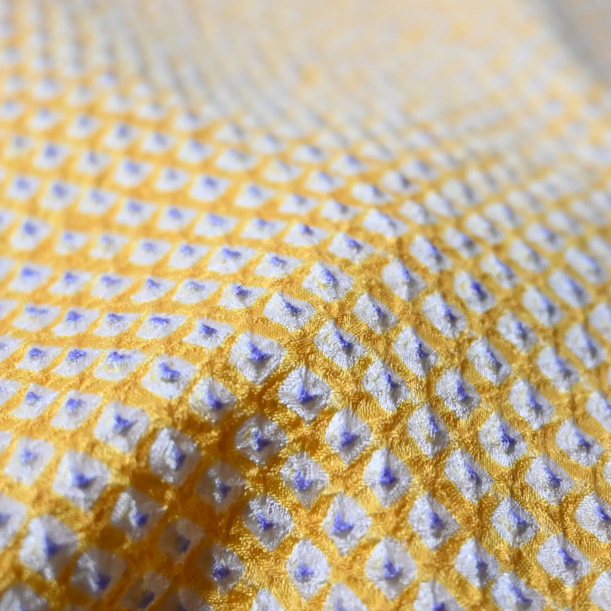 Close-up view of vintage women's silk shibori haori in pastel yellow tone.