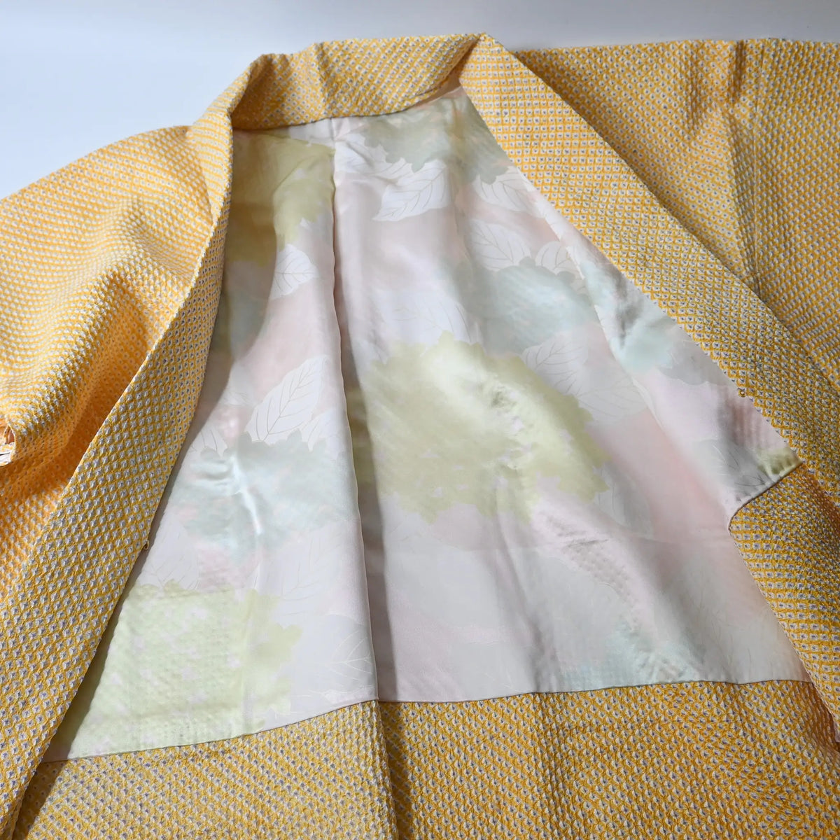 Vintage women's silk shibori haori in pastel yellow tone.