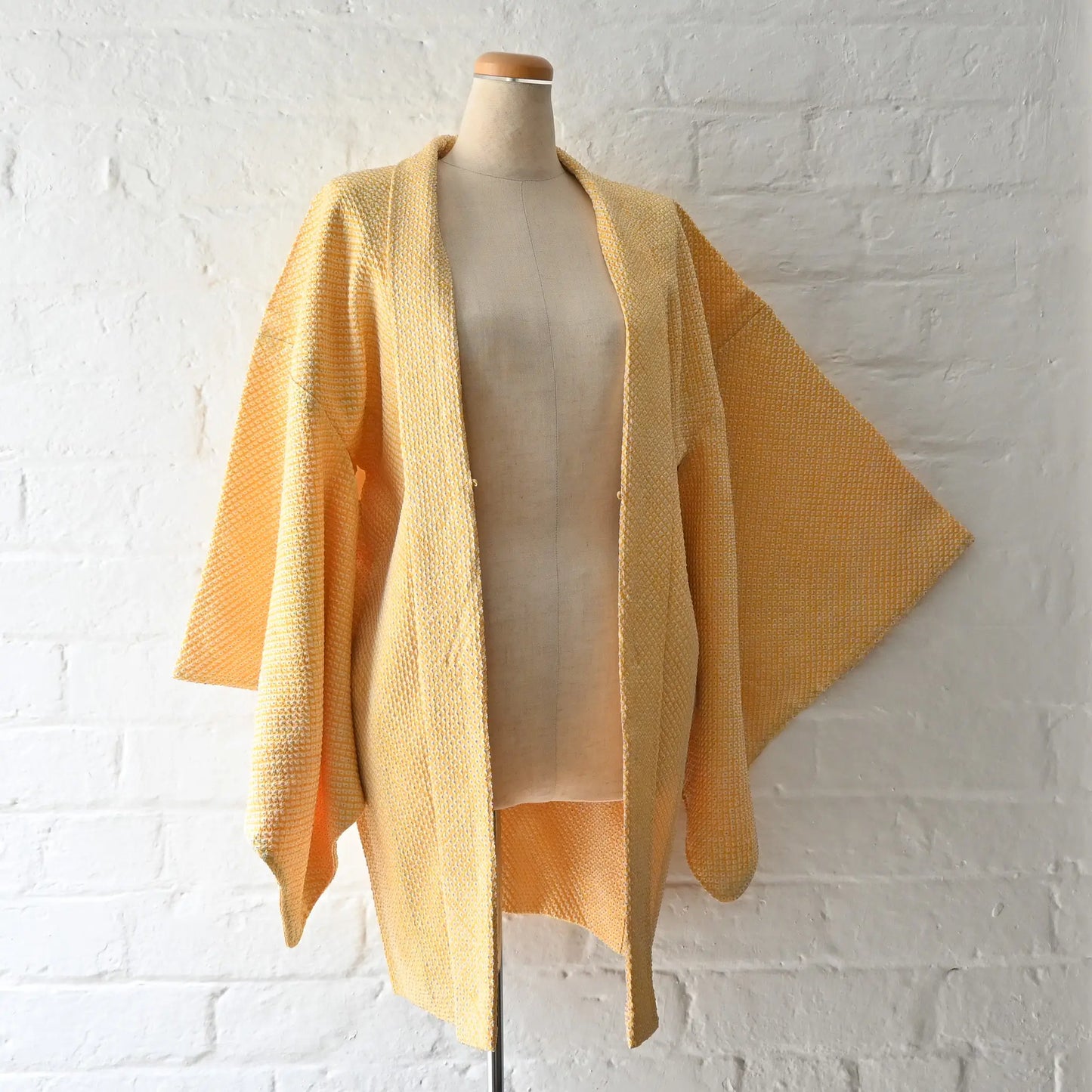 Vintage women's silk shibori haori in pastel yellow tone.
