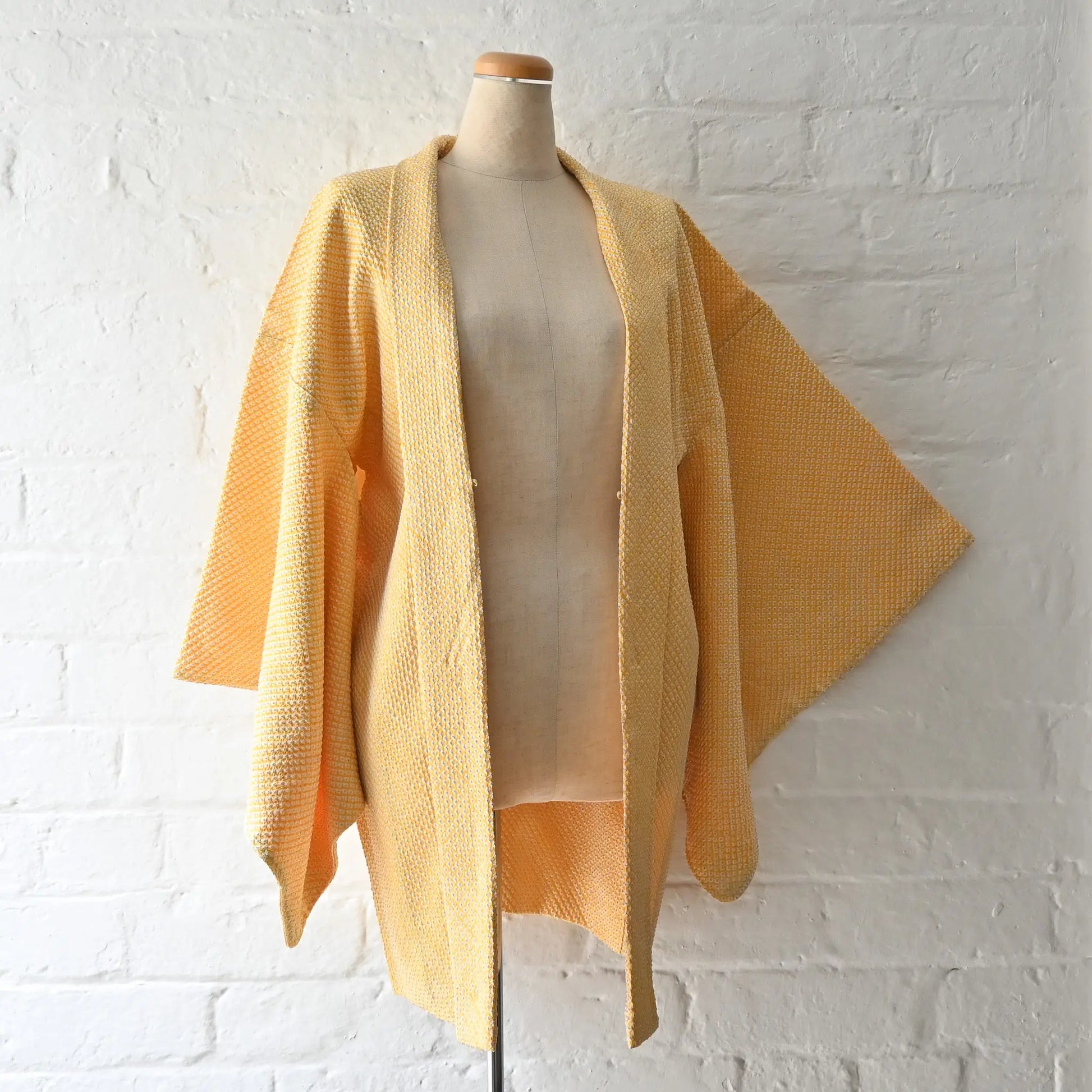 Vintage women's silk shibori haori in pastel yellow tone.