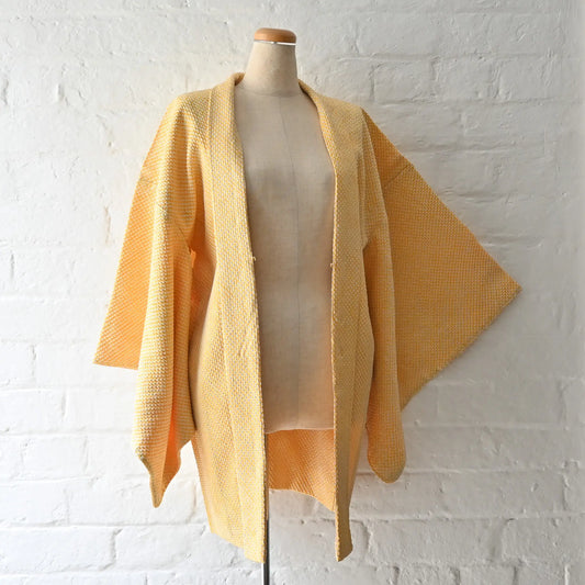 Vintage women's silk shibori haori in pastel yellow tone.