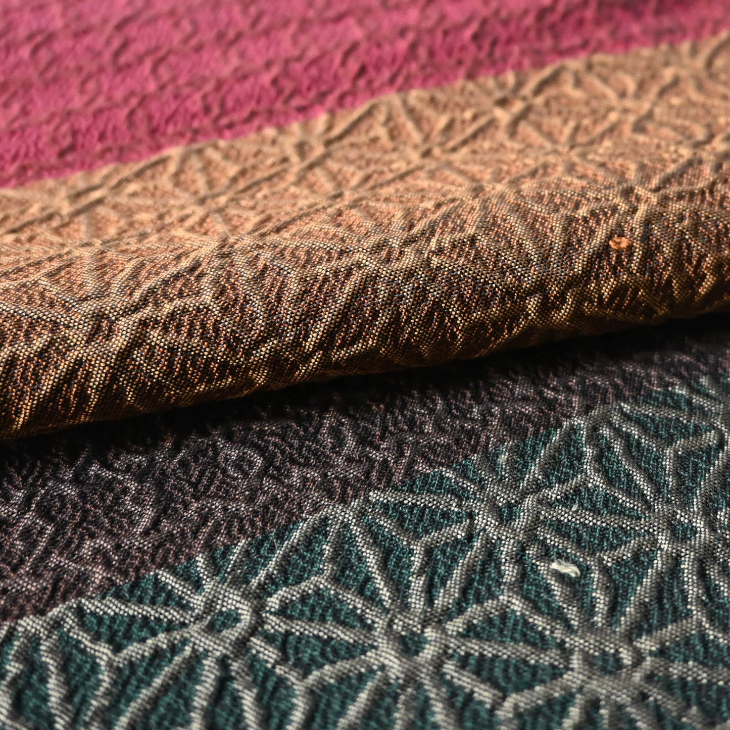 Close-up view of vintage Japanese women's silk textured geometric design Fukuro obi in warm rustic tones.