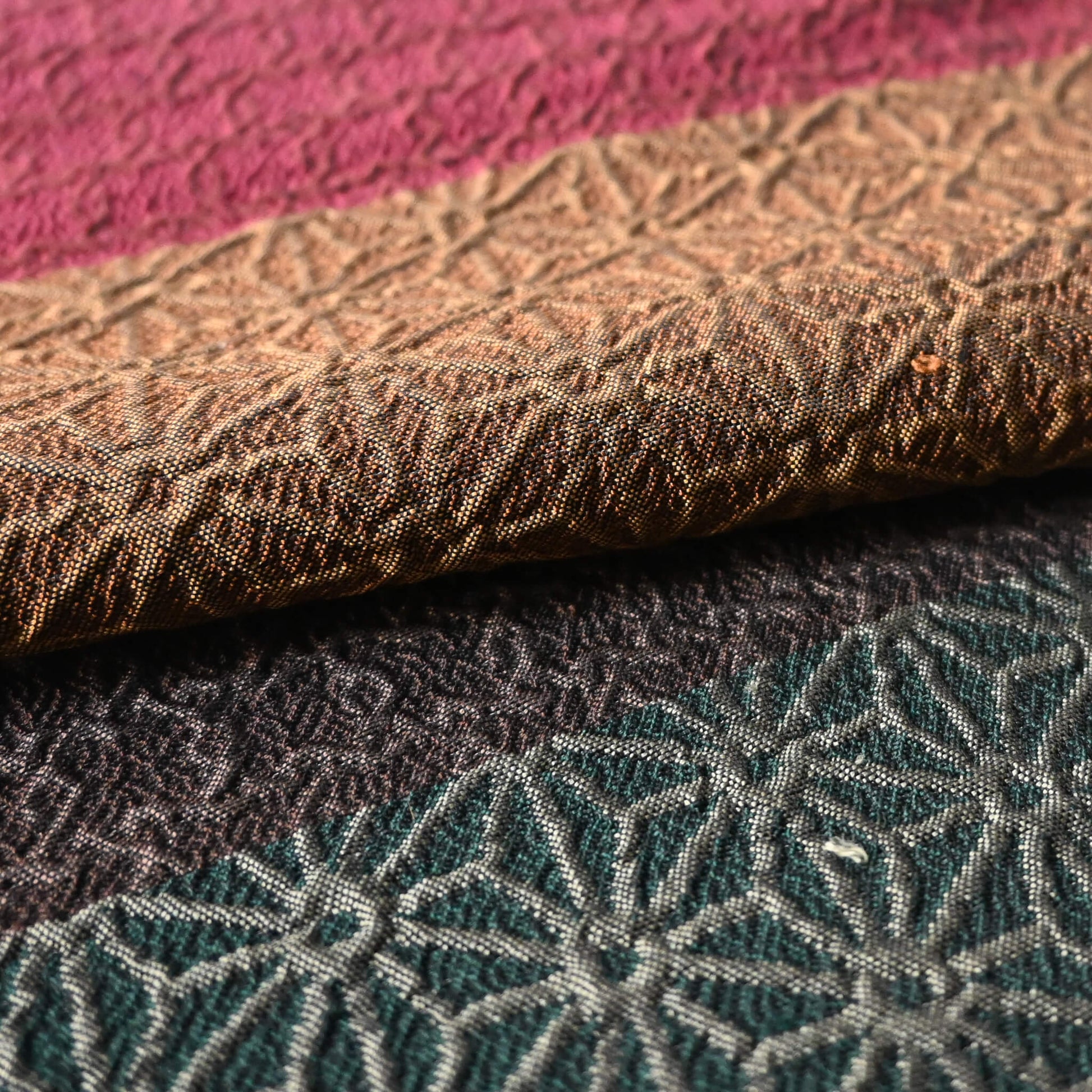 Close-up view of vintage Japanese women's silk textured geometric design Fukuro obi in warm rustic tones.