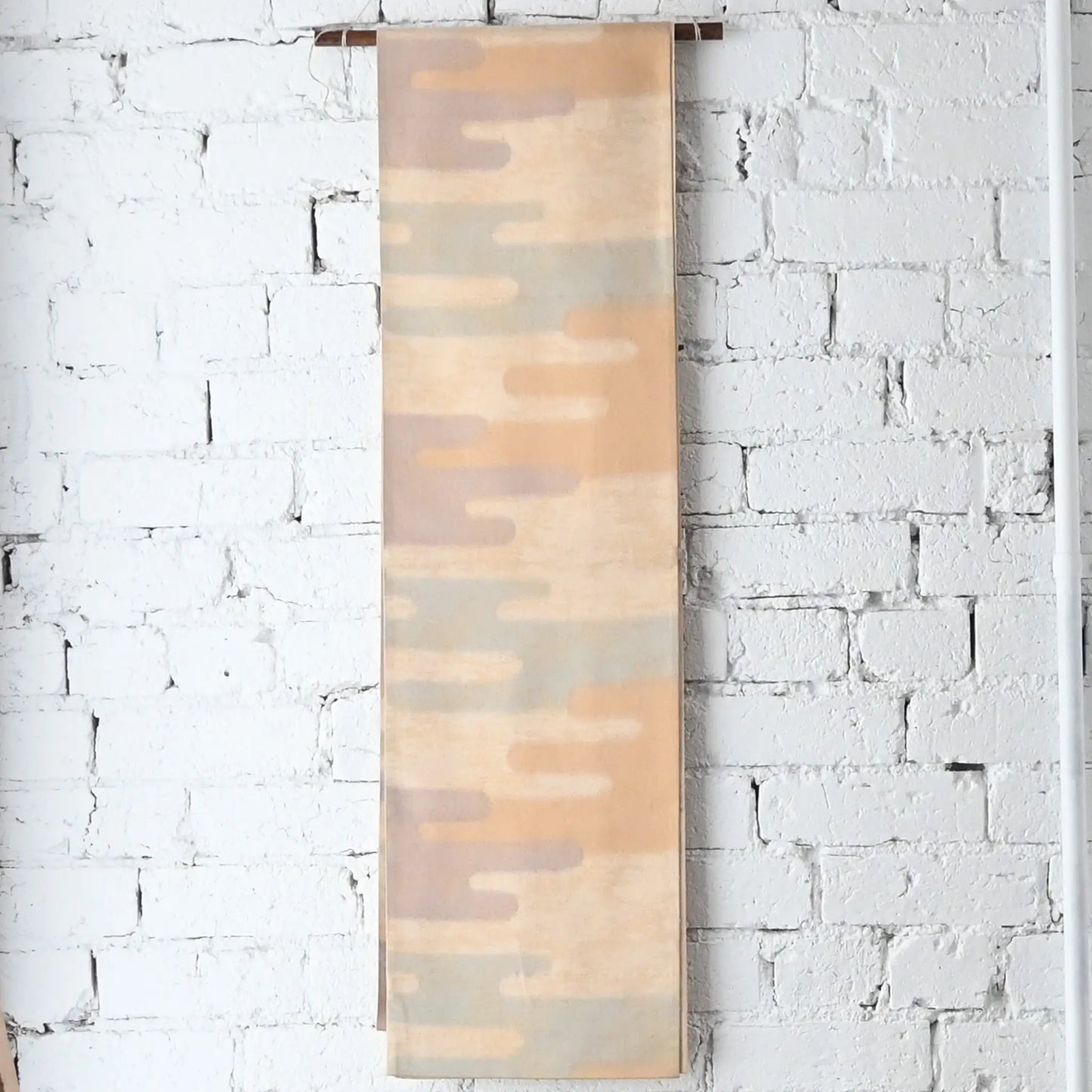 Hanging view of vintage Japanese women's silk Fukuro Obi in soft gold, purple and blue with Kasumi pattern.