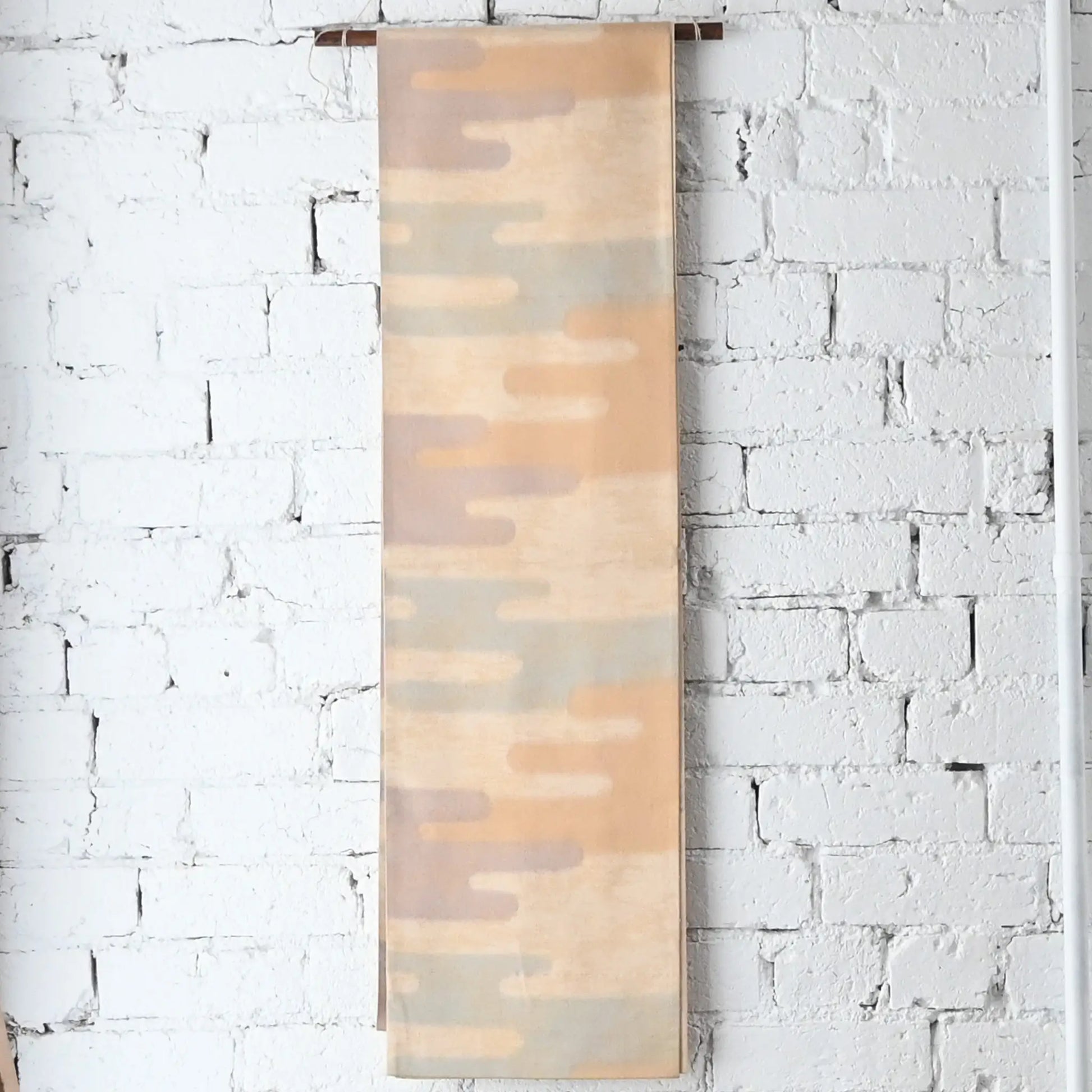 Hanging view of vintage Japanese women's silk Fukuro Obi in soft gold, purple and blue with Kasumi pattern.