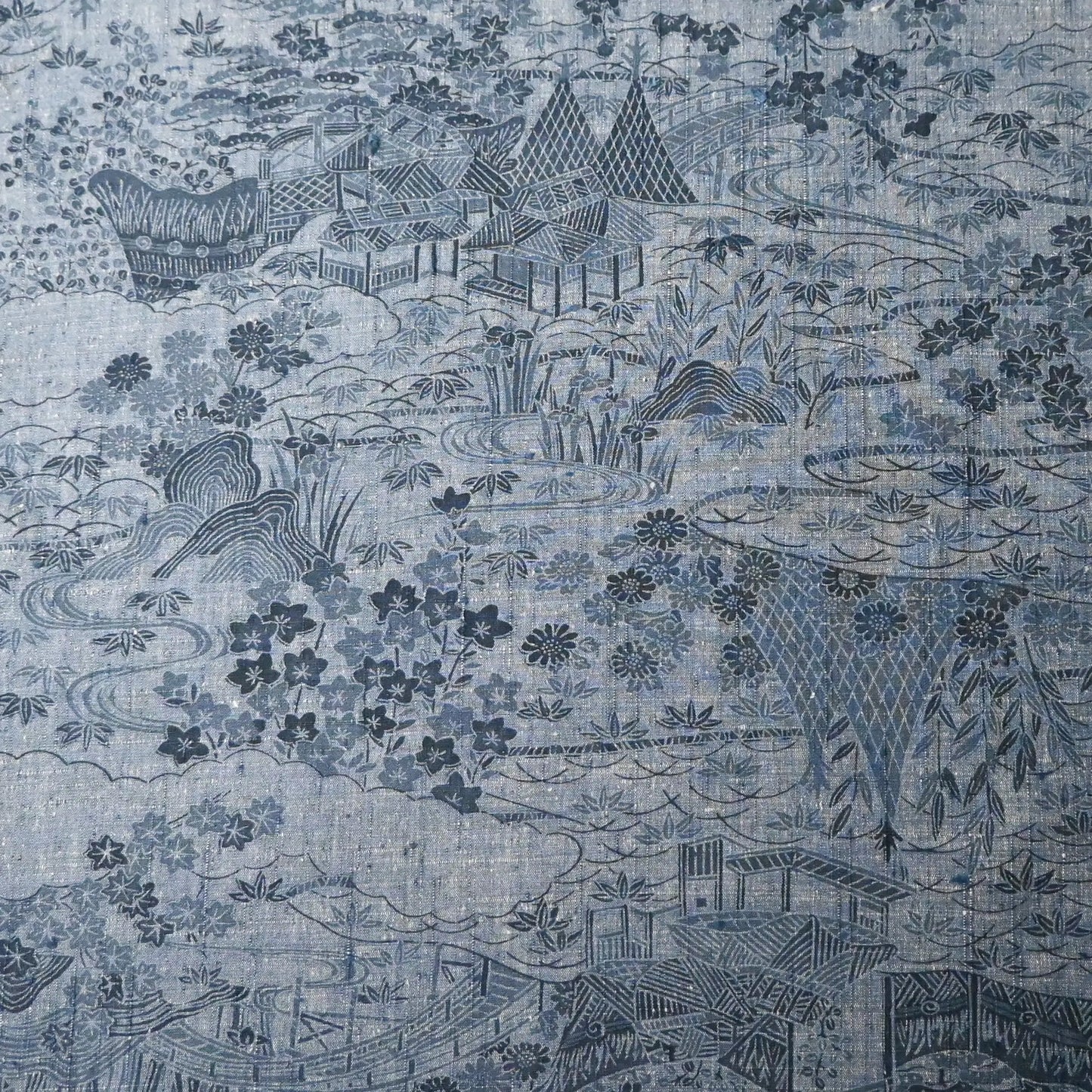 Vintage women's tsumugi silk kimono fabric in soft steel blue with village scenery pattern.