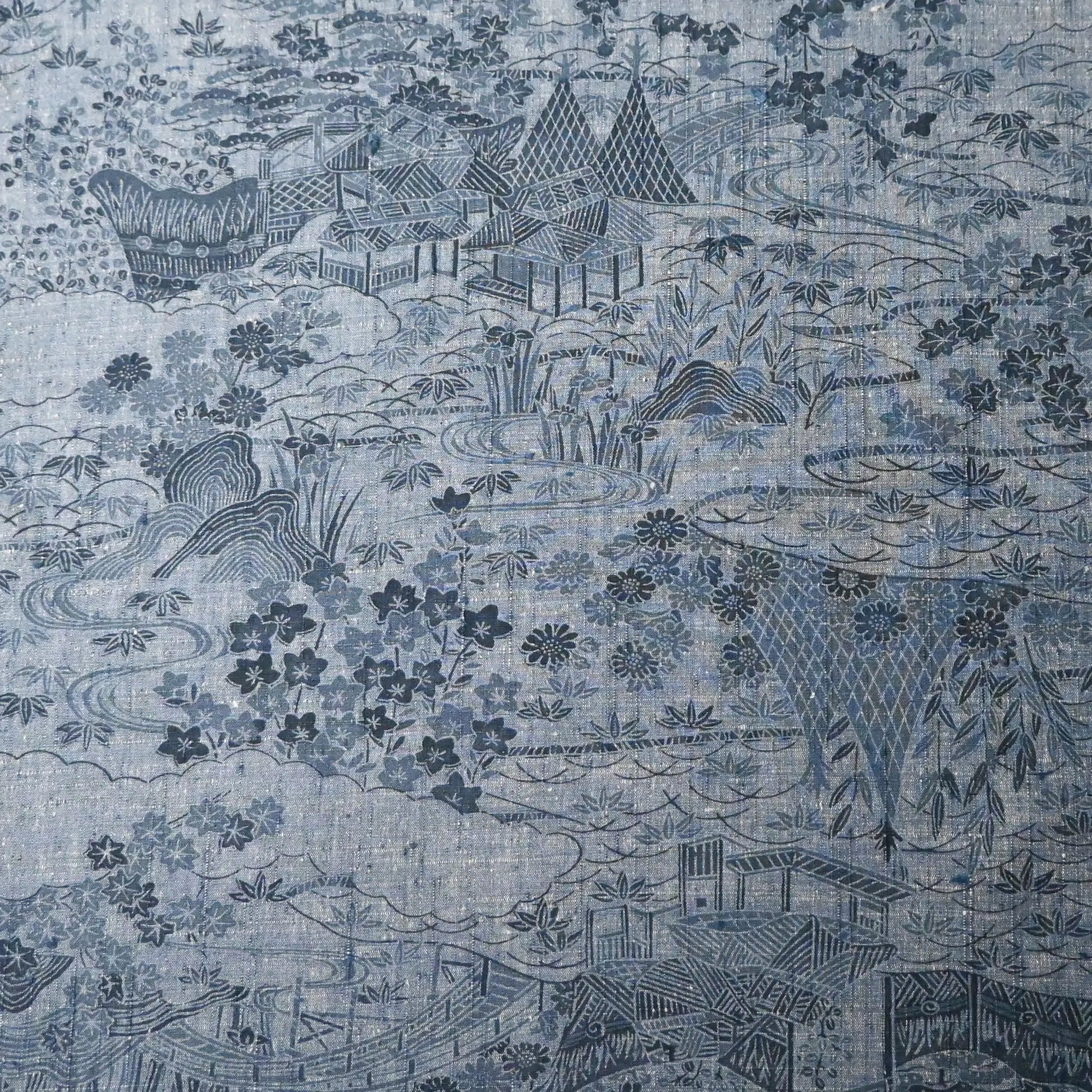 Vintage women's tsumugi silk kimono fabric in soft steel blue with village scenery pattern.